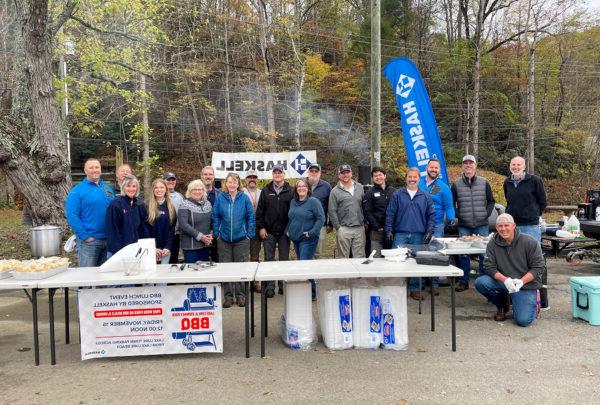 Team members from 澳门足彩app’s Charlotte office prepare to serve barbecue meals to residents and recovery workers in Lake Lure, North Carolina, a small mountain town devastated by Hurricane Helene.